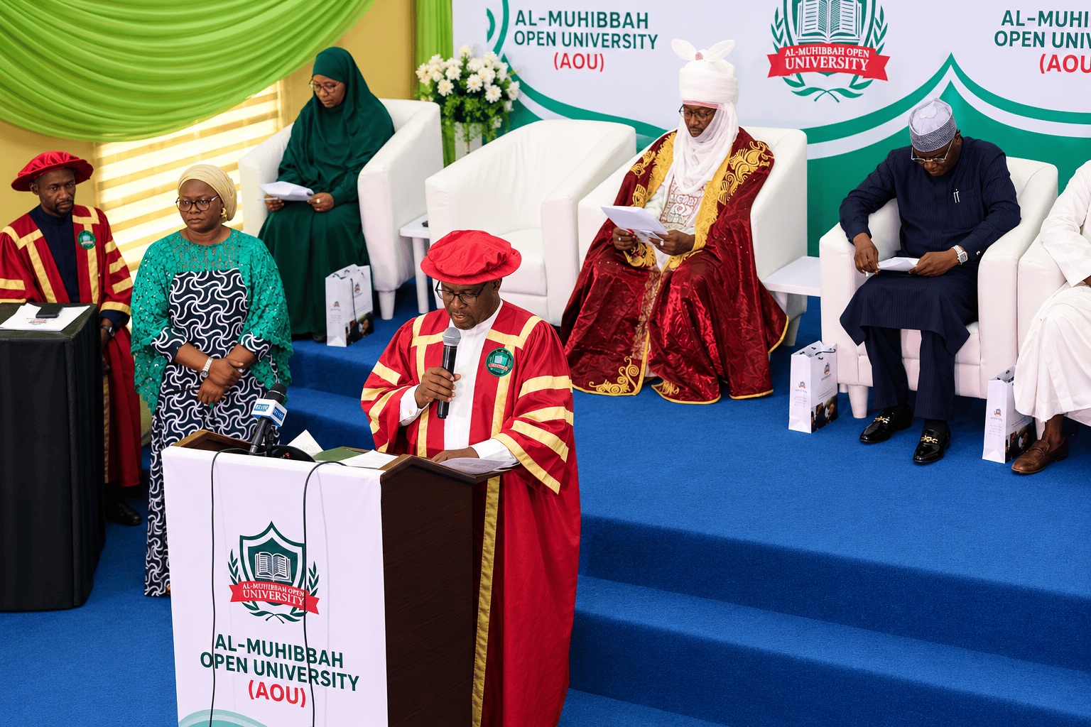 Al-Muhibbah Open University event with speakers and attendees on stage.
